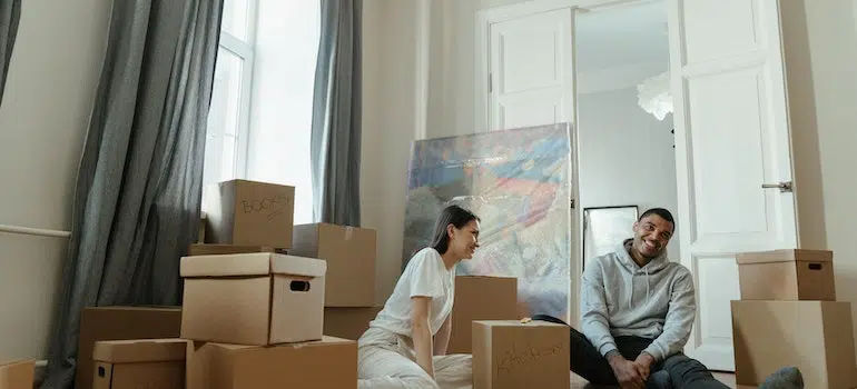Two people in a relationship packing their home together