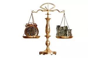 A scale measuring a clock on one end and money on the other