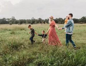 a family walking through a field in Franklin Park as a depiction of where do young parents move to