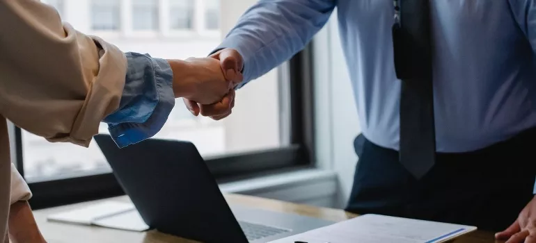 Two persons shaking hands at the office