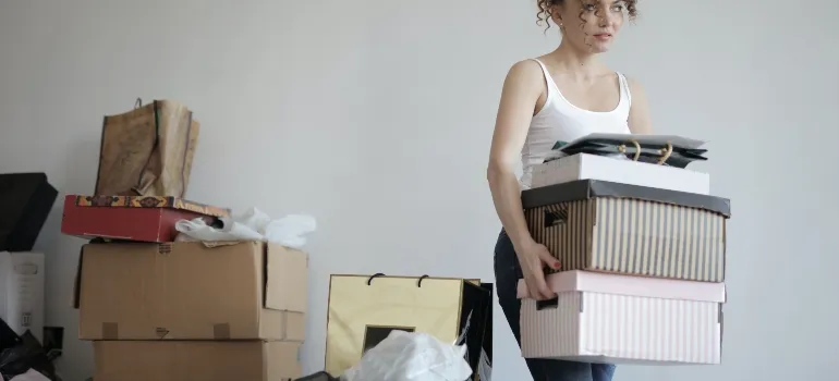A woman carrying boxes