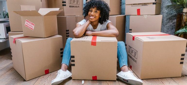 A happy girl thinking about calling movers Cedar Grove offers
